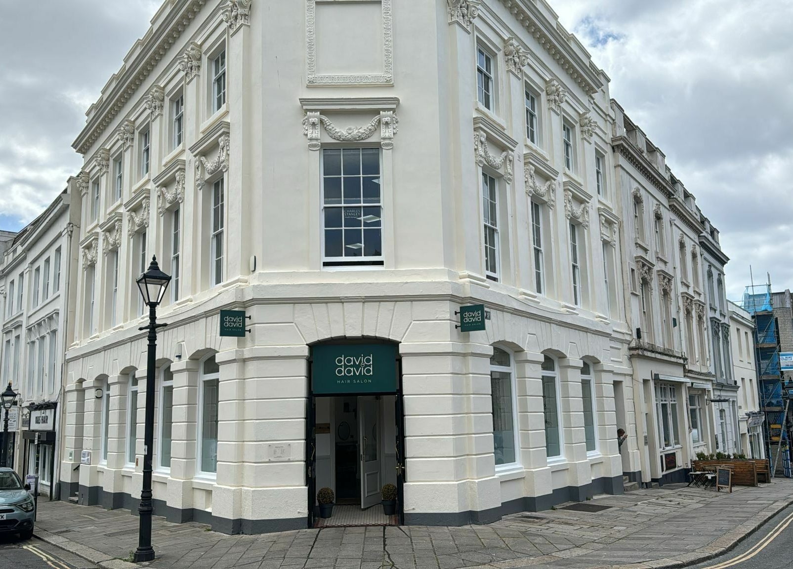 Front view of David & David beauty salon on a historic street corner in Plymouth, England, GB.