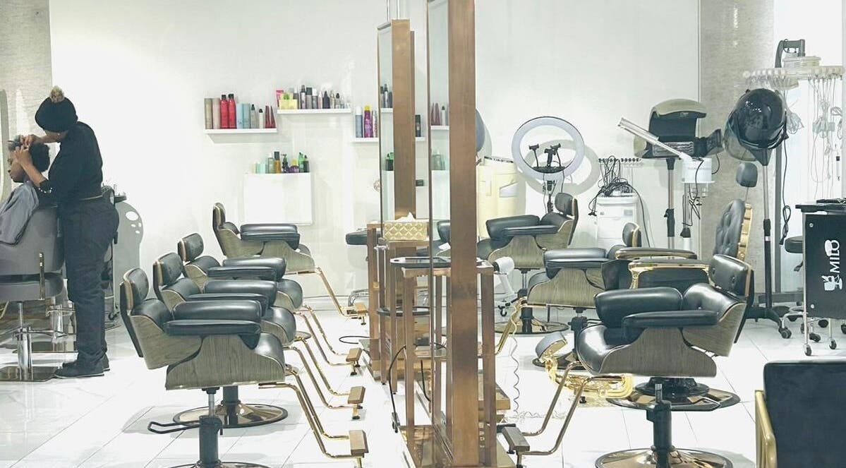 Modern interior of SK Hair Salon in Montréal, Québec, CA with stylish salon chairs and hairdressing stations.
