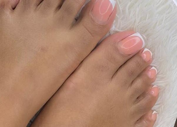 Elegant French pedicure at Philly's Beauty Bar, Benoni, Gauteng, ZA showcasing pampered feet.