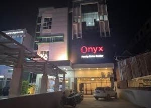 Onyx Family Relax Center entrance at night, Kalimantan Barat, ID, warmly lit for a welcoming ambiance.