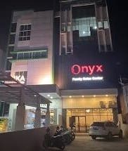 Onyx Family Relax Center entrance at night, Kalimantan Barat, ID, warmly lit for a welcoming ambiance.
