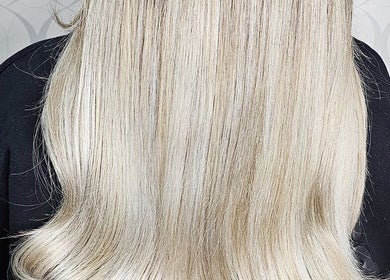 Sleek blonde hair styled at HAIRBYGINGERMTL in Montréal, Québec, CA showcases expert hairstyling.