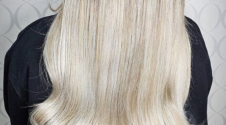 Sleek blonde hair styled at HAIRBYGINGERMTL in Montréal, Québec, CA showcases expert hairstyling.