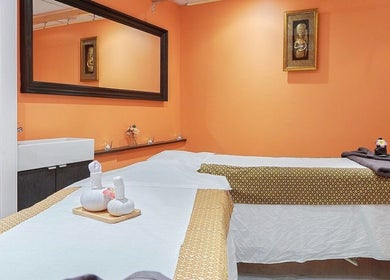 Tranquil massage room at Eleven Thai Therapy, London, England, GB with warm tones and elegant decor.
