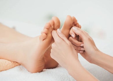Foot massage at Eleven Thai Therapy, London, England, GB, showcasing expert relaxation techniques.