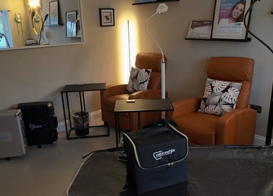 Relaxing seating area at The Pearly Bright in Blantyre, Scotland, GB, showcasing plush chairs and modern decor.