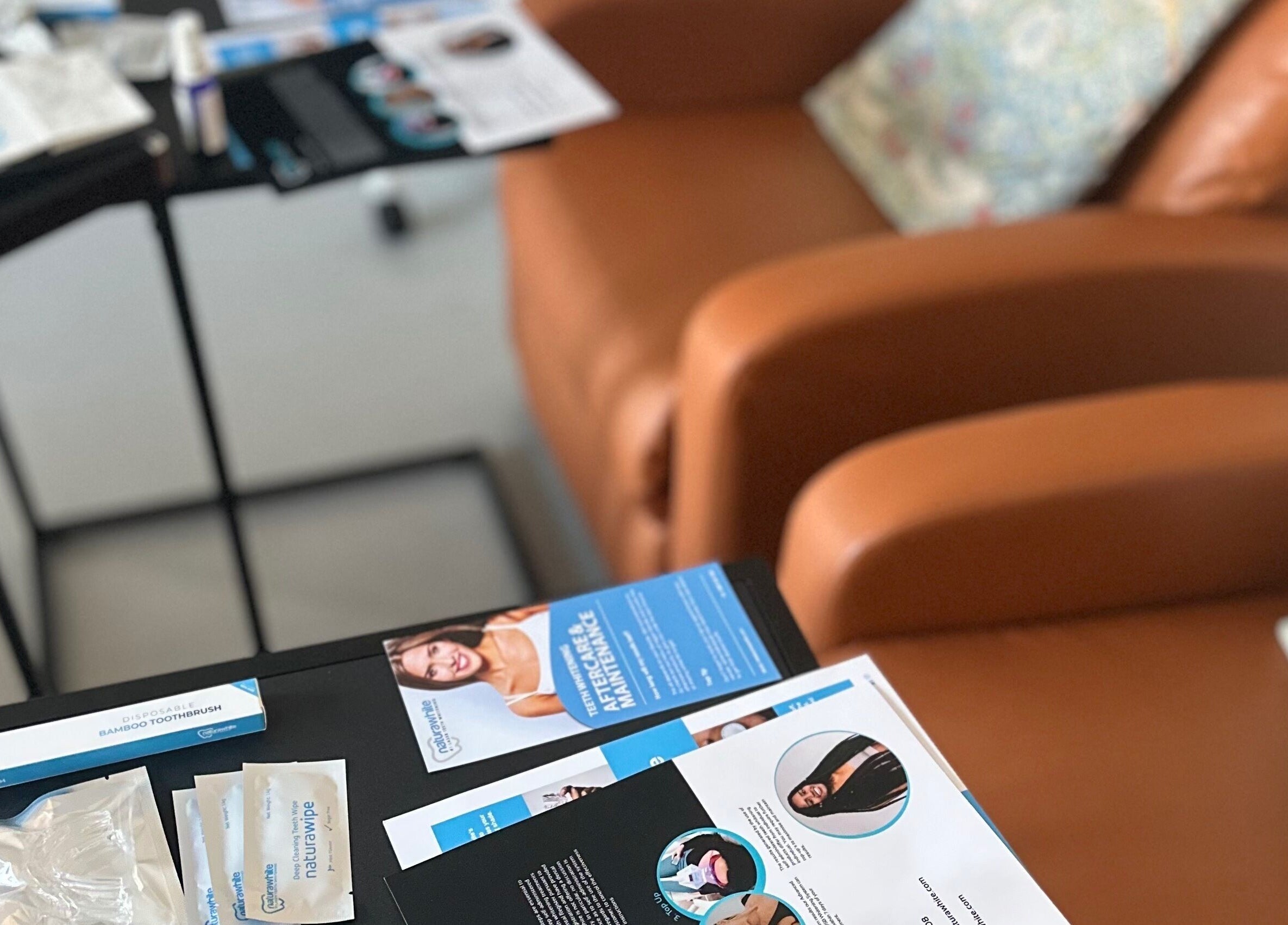 Cozy seating area at The Pearly Bright, Blantyre, Scotland, GB, showcasing brochures and welcoming ambiance.