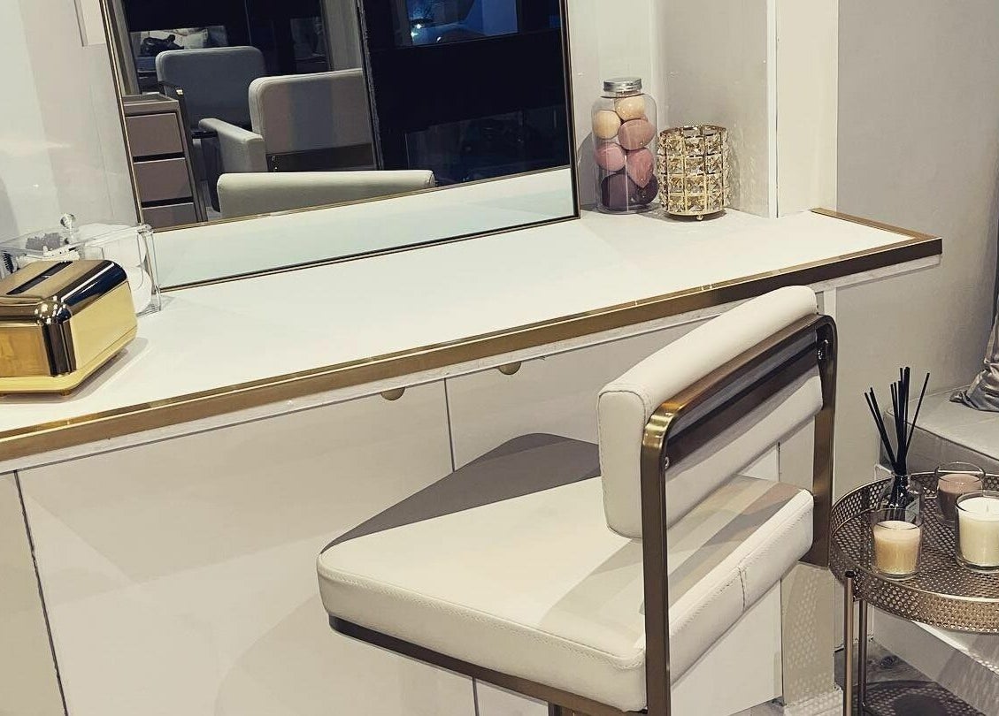 Luxurious makeup station at Salon23, Glasgow, Scotland, GB, featuring gold accents and candles.