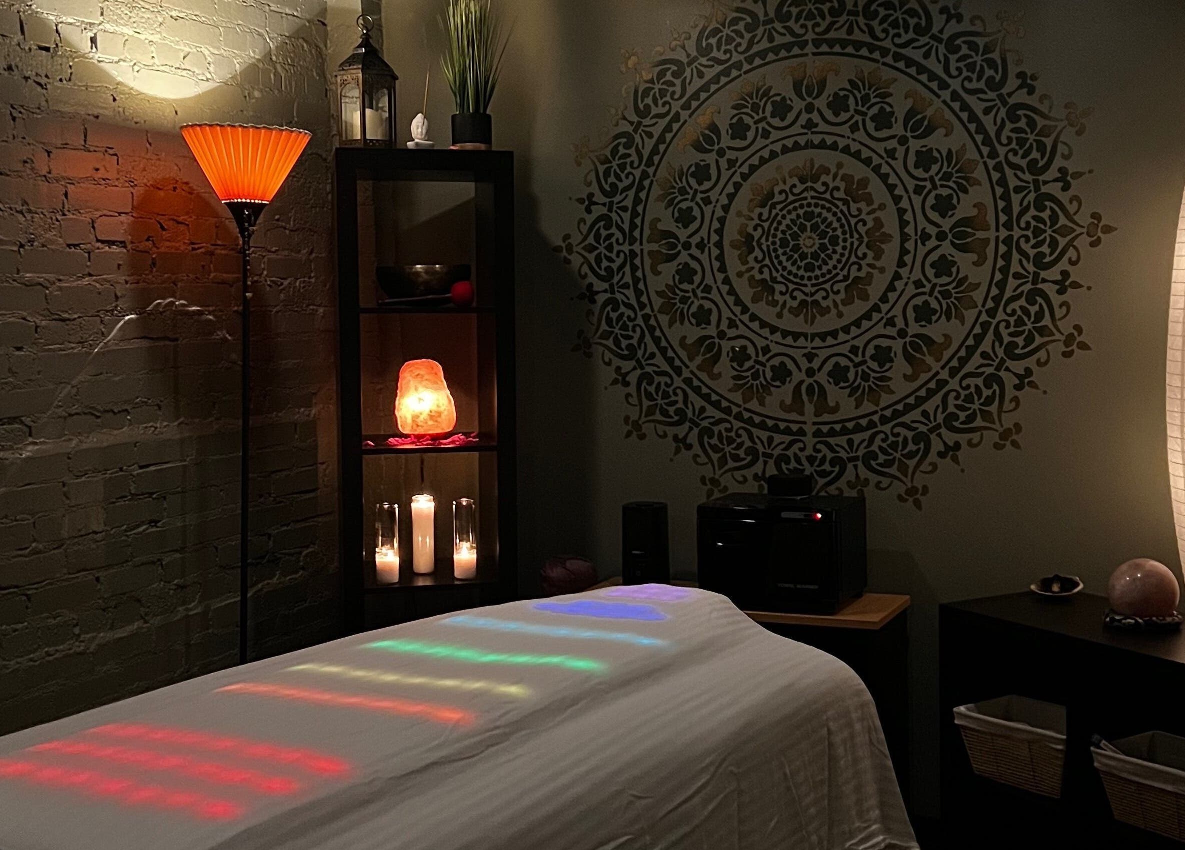 Spa room at Latisa at Oasis at the Mill, Winston-Salem, NC, US, featuring soft lighting and a massage table.