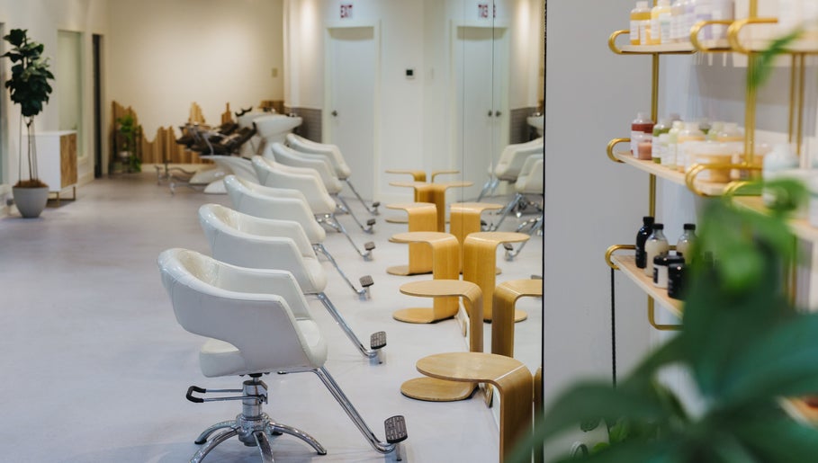 Modern interior of Salon Esprit in Vancouver, British Columbia, CA with stylish chairs and products displayed.
