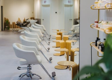 Modern interior of Salon Esprit in Vancouver, British Columbia, CA with stylish chairs and products displayed.