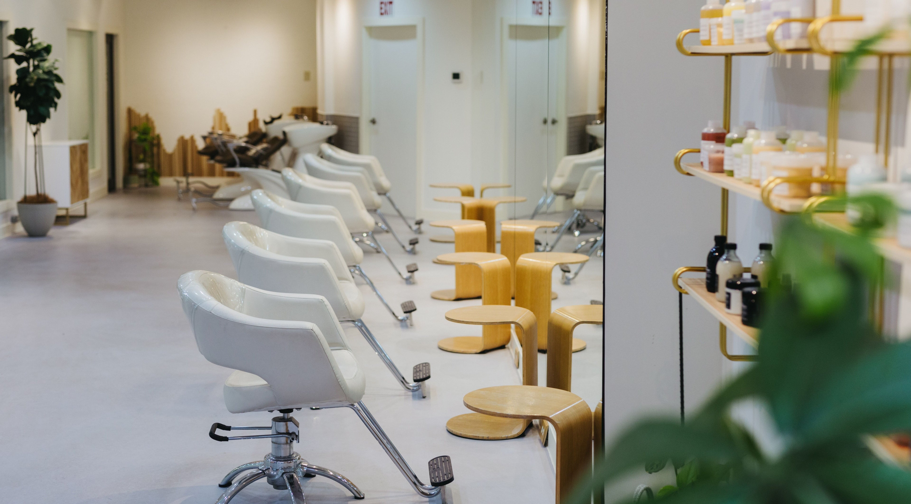 Modern interior of Salon Esprit in Vancouver, British Columbia, CA with stylish chairs and products displayed.