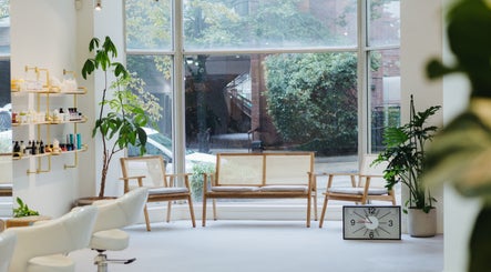 Relaxing seating at Salon Esprit, Vancouver, British Columbia, CA with stylish decor and large windows.