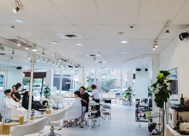 Modern interior of Salon Esprit in Vancouver, British Columbia, CA with clients receiving hair treatments.