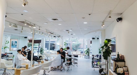 Modern interior of Salon Esprit in Vancouver, British Columbia, CA with clients receiving hair treatments.