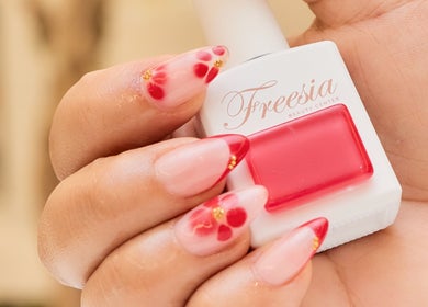 Chic red and gold nail art from Fressia Beauty & Wellness Center - Al Riyadh City, Abu Dhabi, Abu Dhabi, AE.