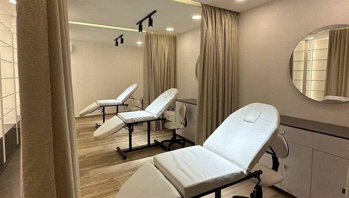 Modern treatment room at Maya Sawaya Beauty Lounge, Jal El Dib, LB, featuring sleek white chairs and soft lighting.