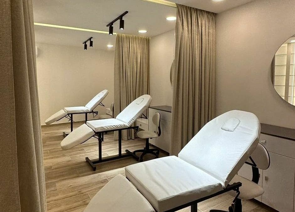 Modern treatment room at Maya Sawaya Beauty Lounge, Jal El Dib, LB, featuring sleek white chairs and soft lighting.