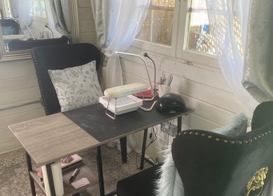 Chic nail care setup at The Beauty Bar in Drumoak, Scotland, GB with plush seating and elegant decor.