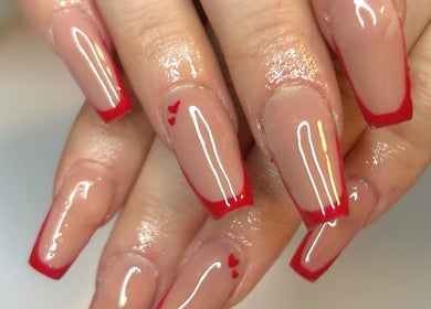 Elegant red tip nails by The Beauty Bar in Drumoak, Scotland, GB showcasing chic nail art design.