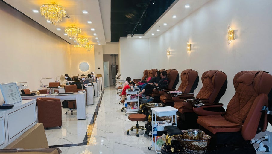 Foxie Nails Lounge in Pickerington, Ohio, US features plush pedicure chairs under elegant chandeliers.