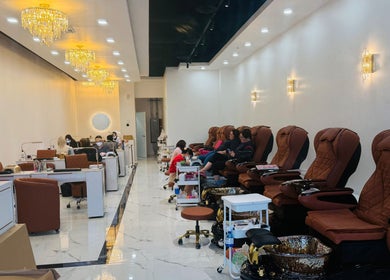 Foxie Nails Lounge in Pickerington, Ohio, US features plush pedicure chairs under elegant chandeliers.