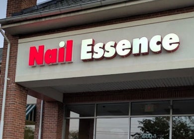Storefront of Nail Essence near Foxie Nails Lounge, Pickerington, Ohio, US, showcasing brick architecture.