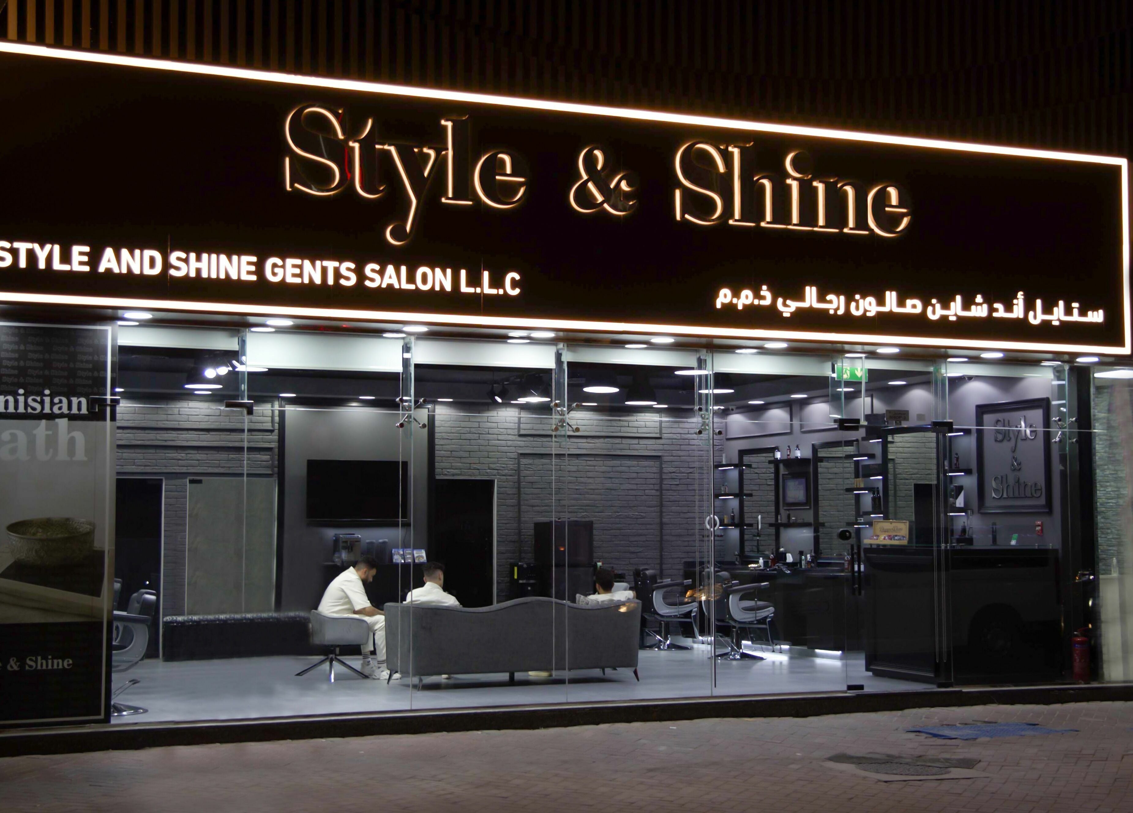 Exterior night view of Style and Shine Gents in Dubai, AE, showcasing modern design and inviting atmosphere.