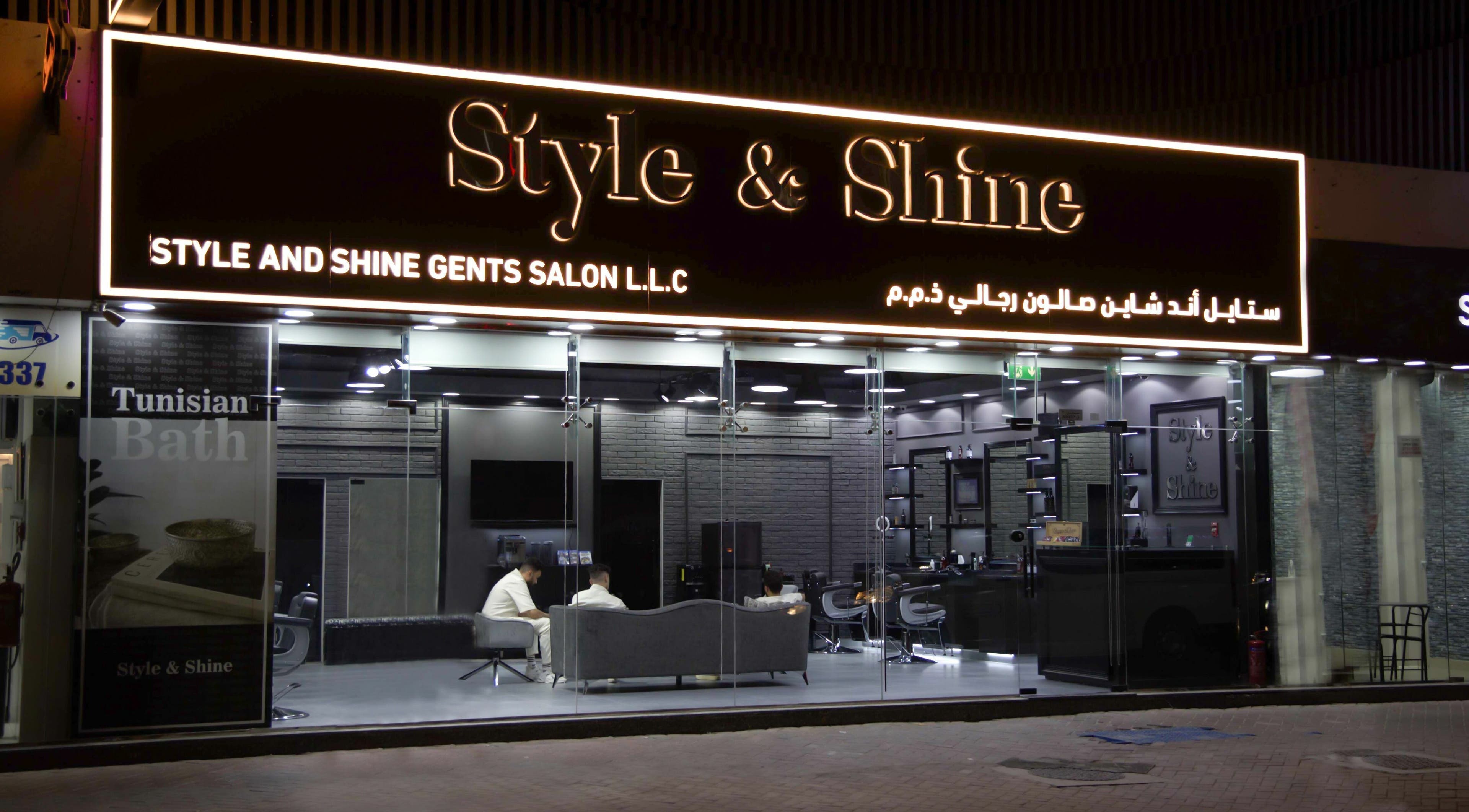 Exterior night view of Style and Shine Gents in Dubai, AE, showcasing modern design and inviting atmosphere.