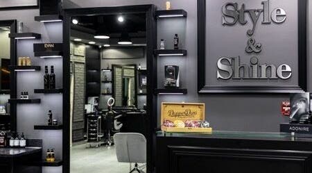 Stylish interior of Style and Shine Gents, Dubai, AE. Modern decor with shelves and grooming products.