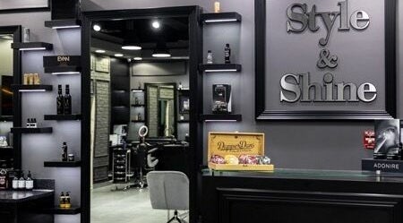 Stylish interior of Style and Shine Gents, Dubai, AE. Modern decor with shelves and grooming products.