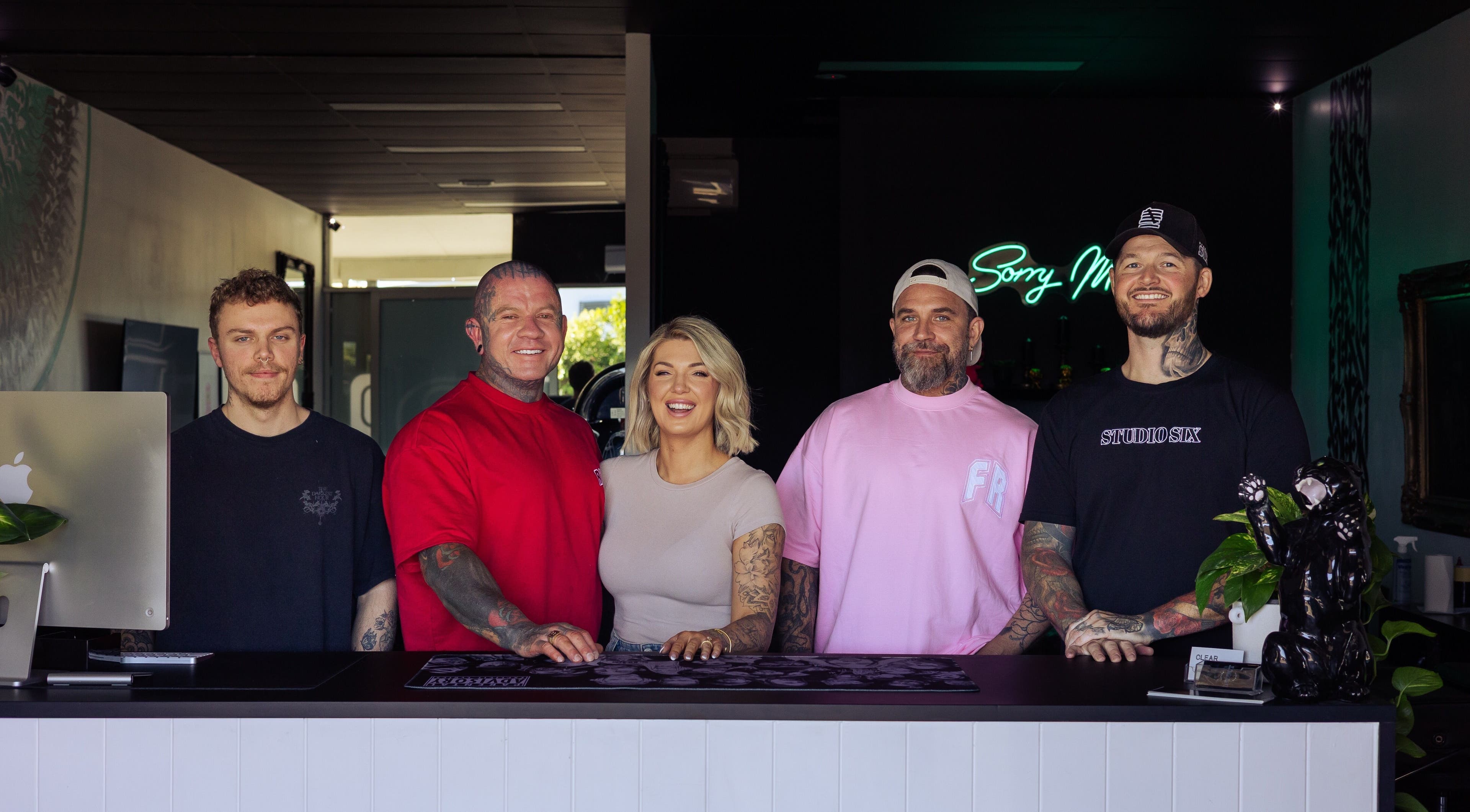 Welcoming team at Studio Six, Wurtulla, Queensland, AU standing at the front desk smiling.