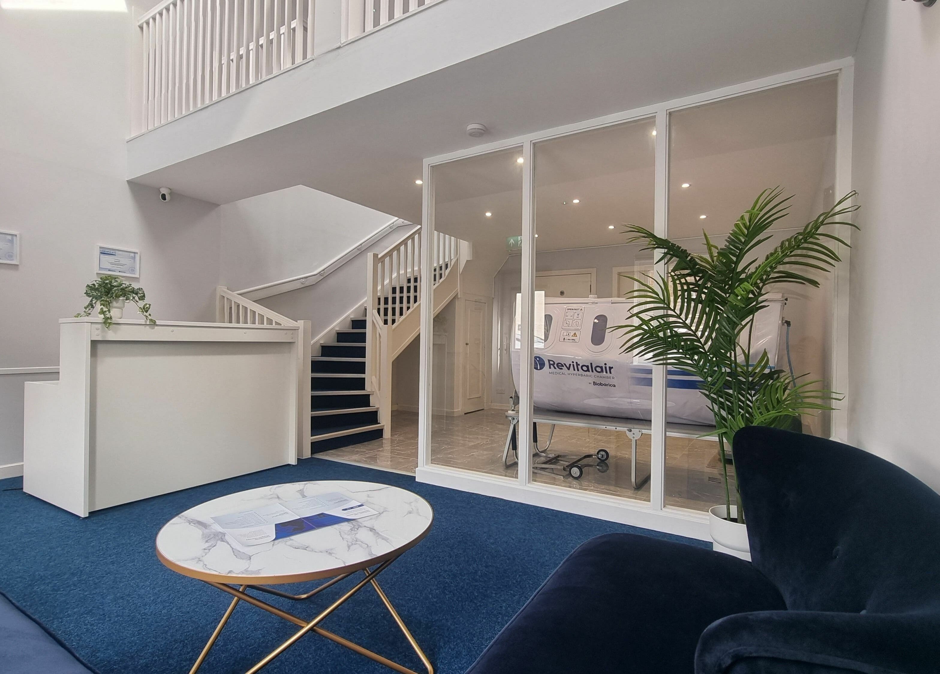Sleek reception at HyperHealth Ltd., Ayr, Scotland, GB, featuring plush seating and green plants.