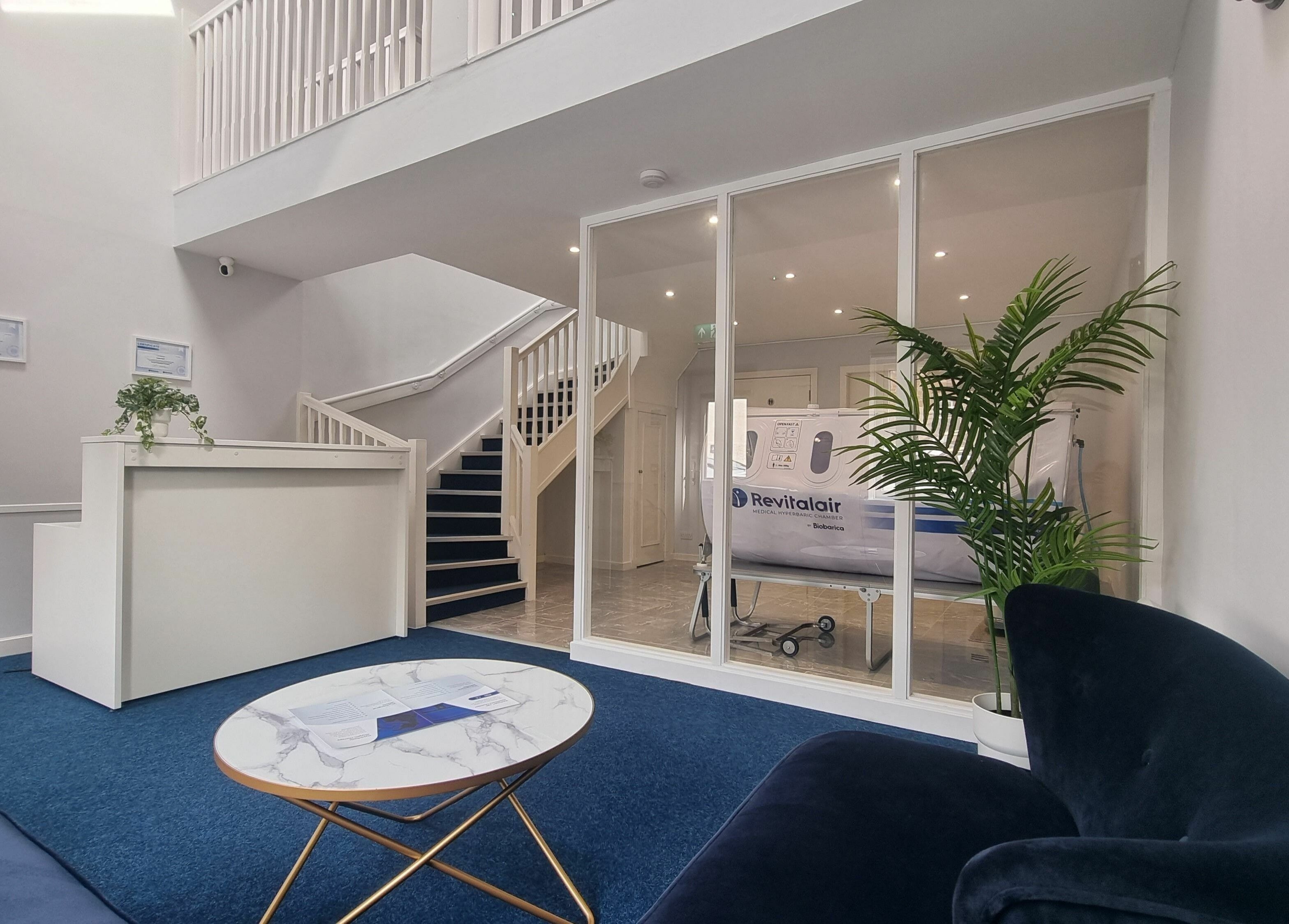 Sleek reception at HyperHealth Ltd., Ayr, Scotland, GB, featuring plush seating and green plants.