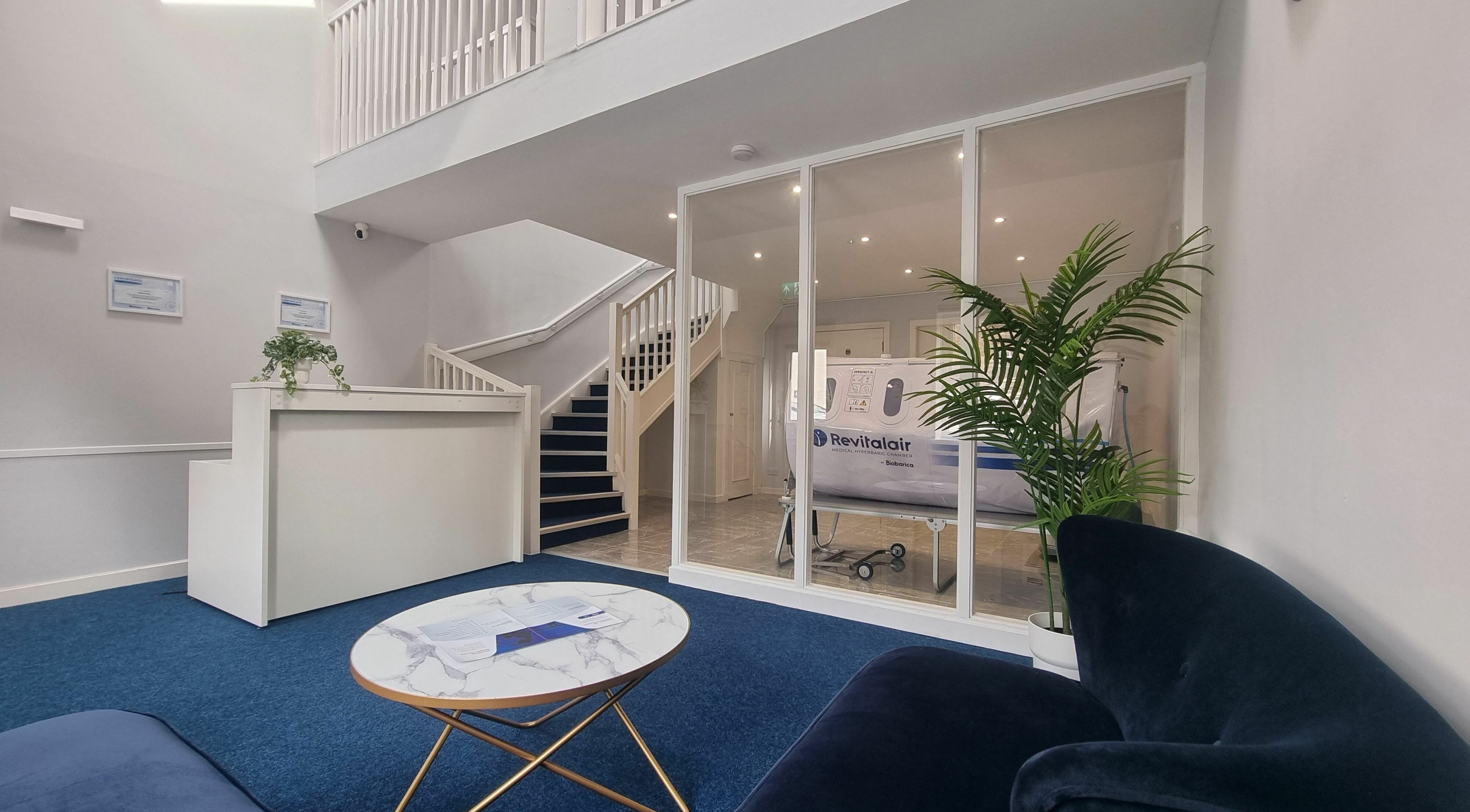 Sleek reception at HyperHealth Ltd., Ayr, Scotland, GB, featuring plush seating and green plants.