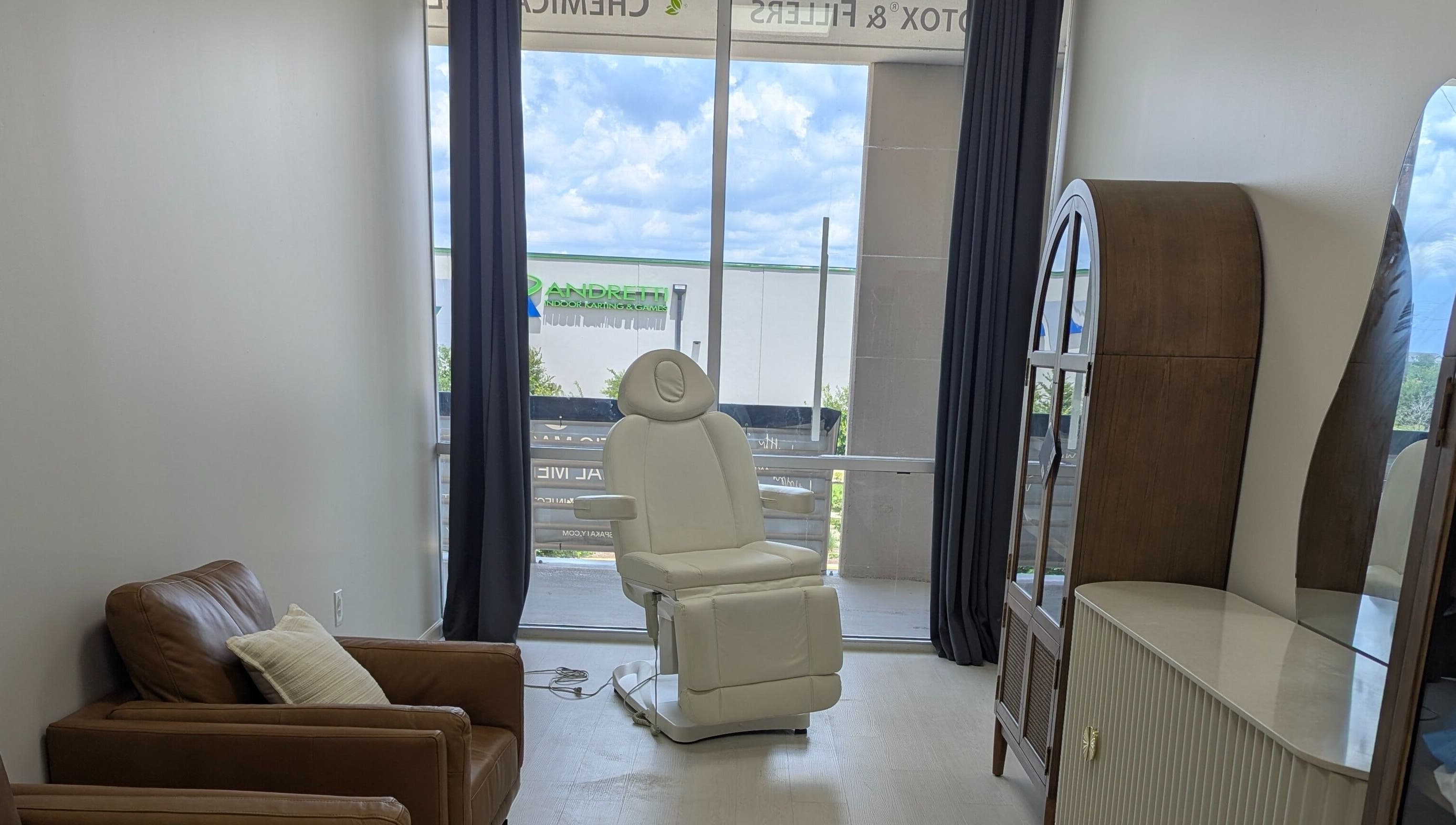 KATY, TX - Identity Aesthetics cozy treatment room with plush chair in Katy, Texas, US.