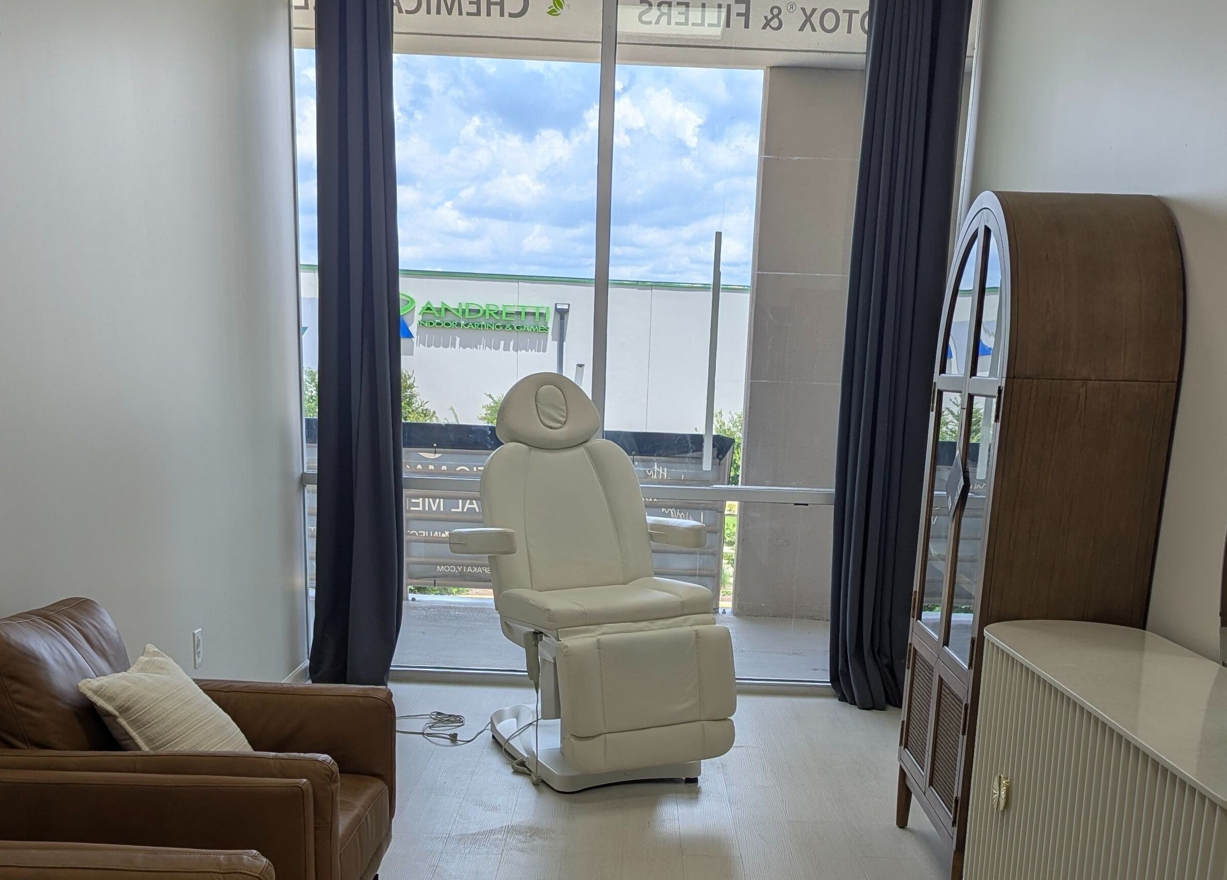 KATY, TX - Identity Aesthetics cozy treatment room with plush chair in Katy, Texas, US.