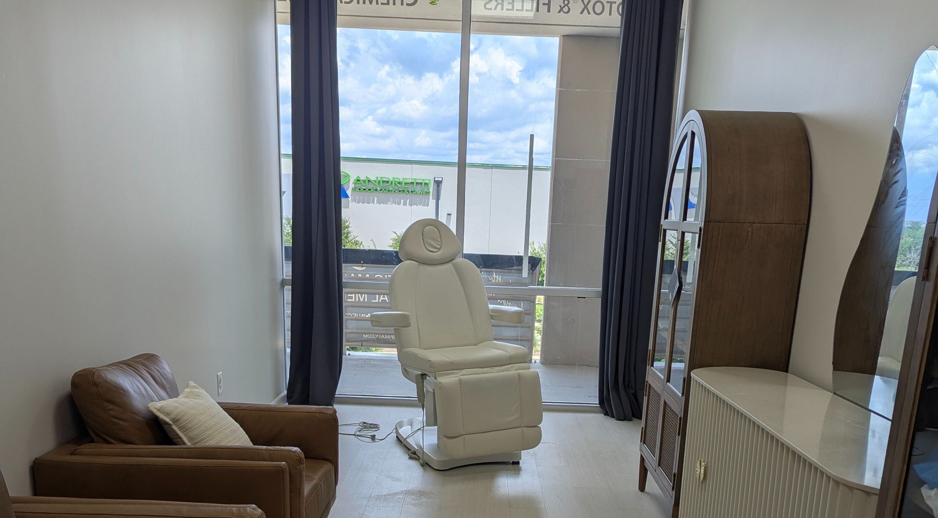 KATY, TX - Identity Aesthetics cozy treatment room with plush chair in Katy, Texas, US.