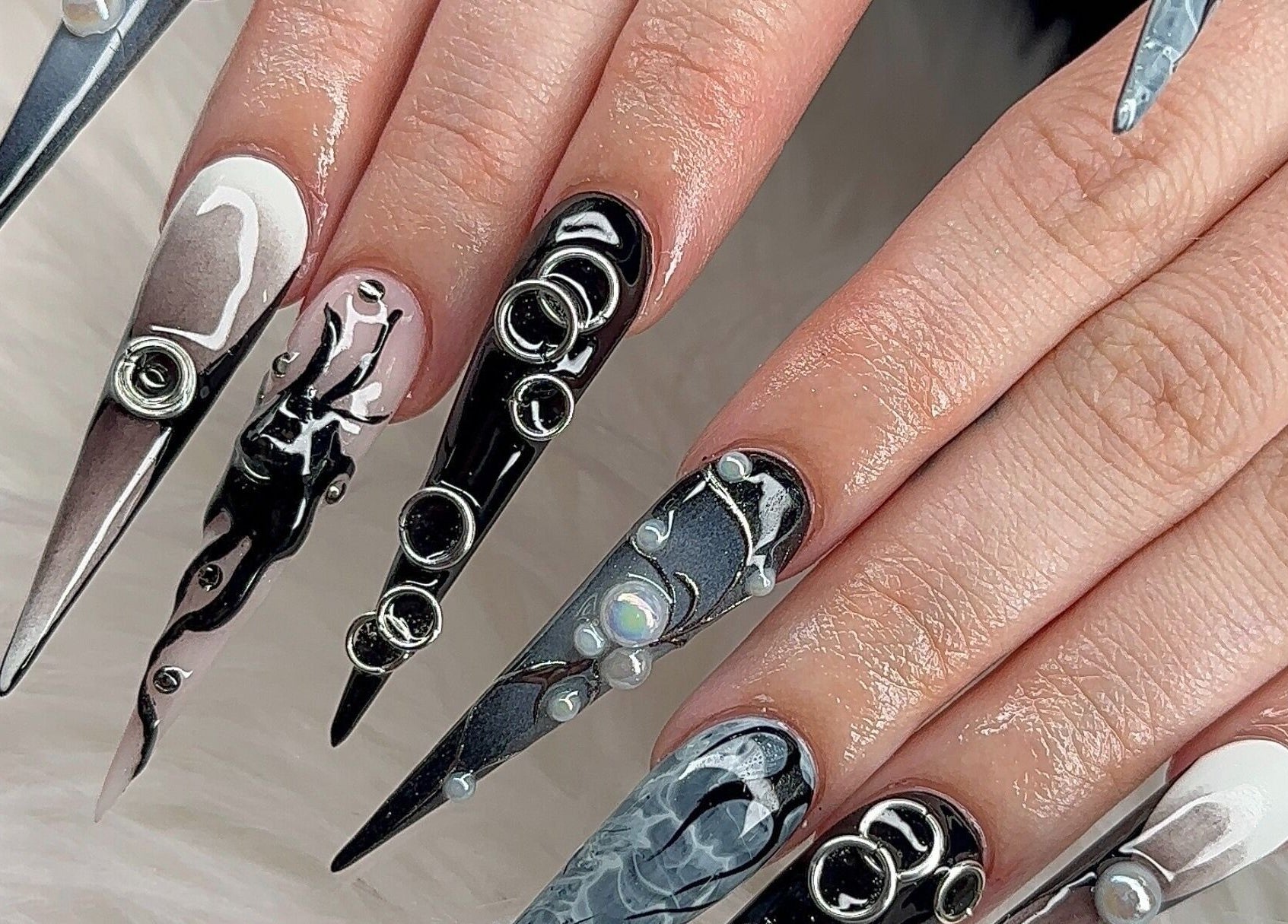 Intricate nail art at Angel Nails & Head Spa in Denton, Texas, US showcasing stylish black and white designs.