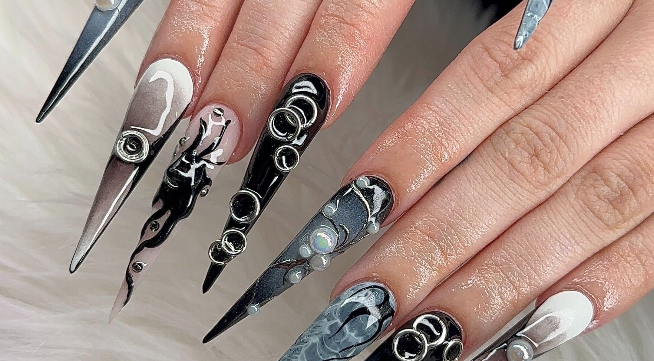 Intricate nail art at Angel Nails & Head Spa in Denton, Texas, US showcasing stylish black and white designs.