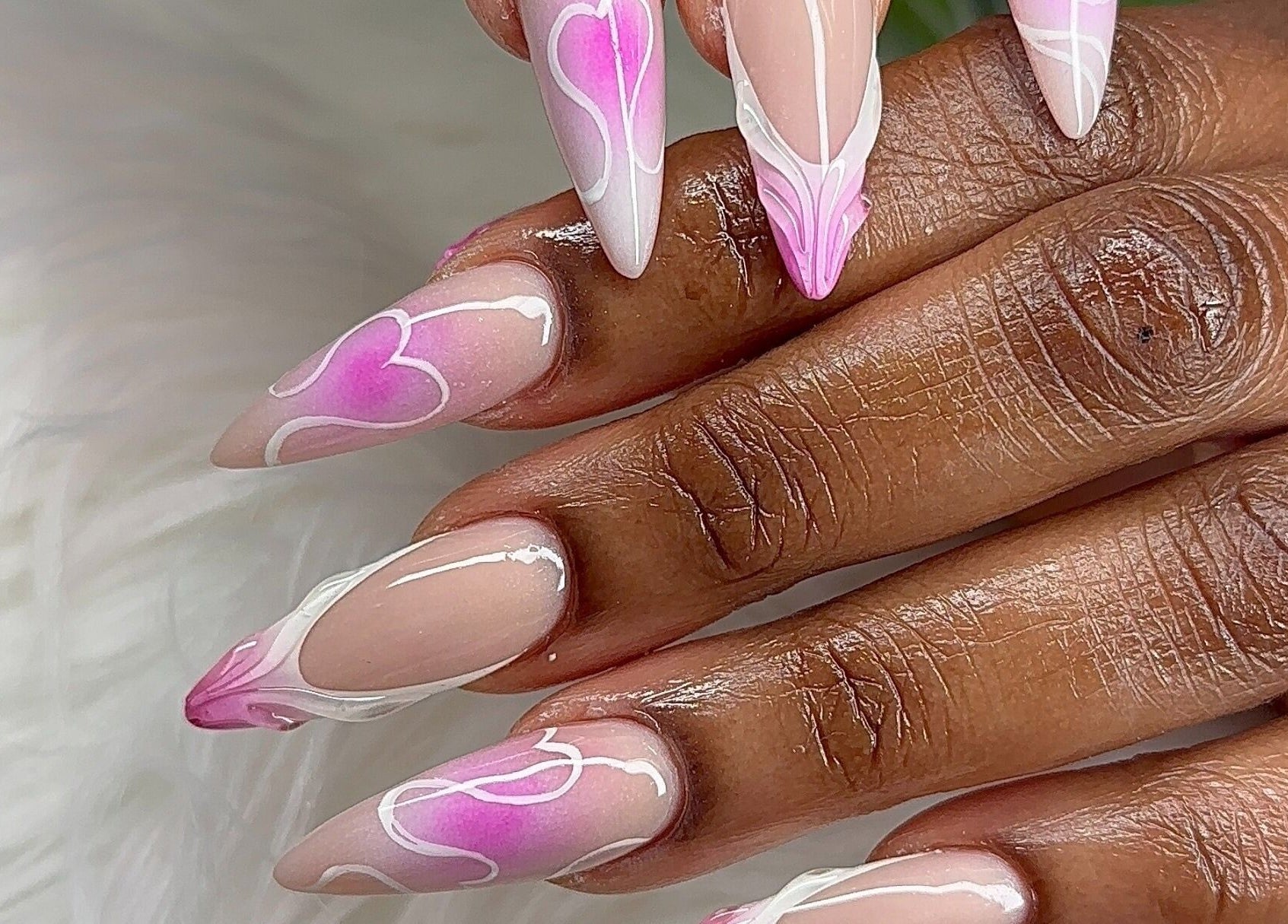 Intricate pink heart nail art at Angel Nails & Head Spa, Denton, Texas, US, showcasing unique nail designs.