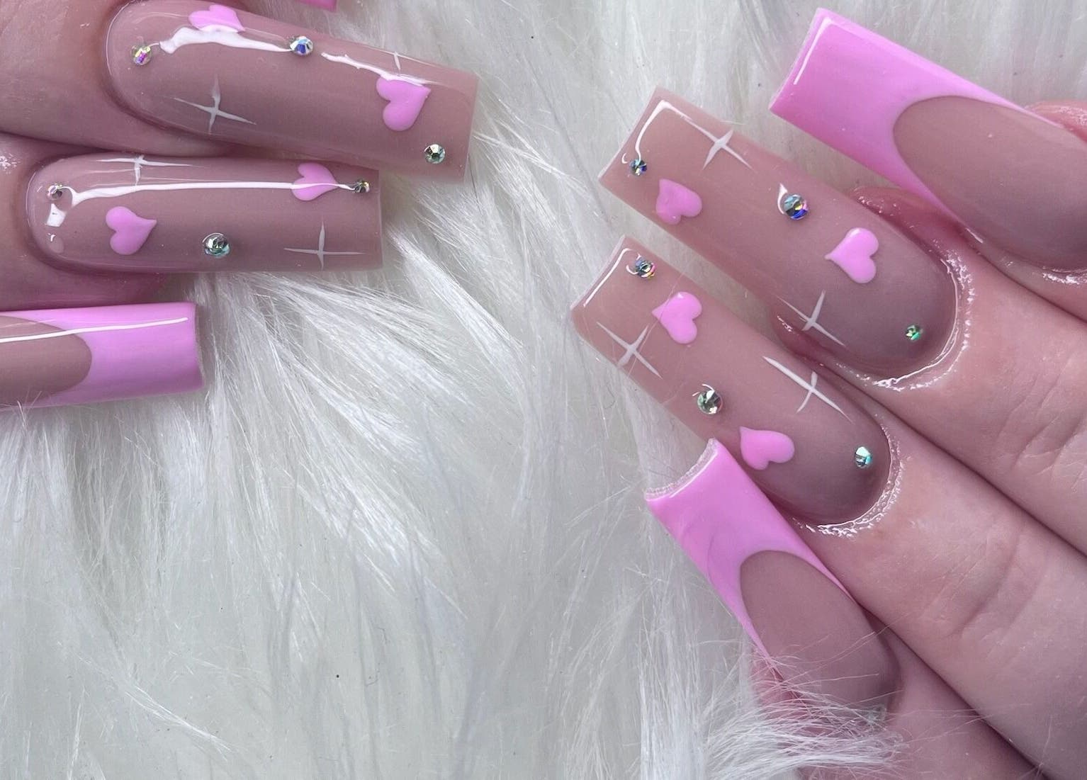 Pink-themed nail art with heart and gem designs at Angel Nails & Head Spa, Denton, Texas, US.