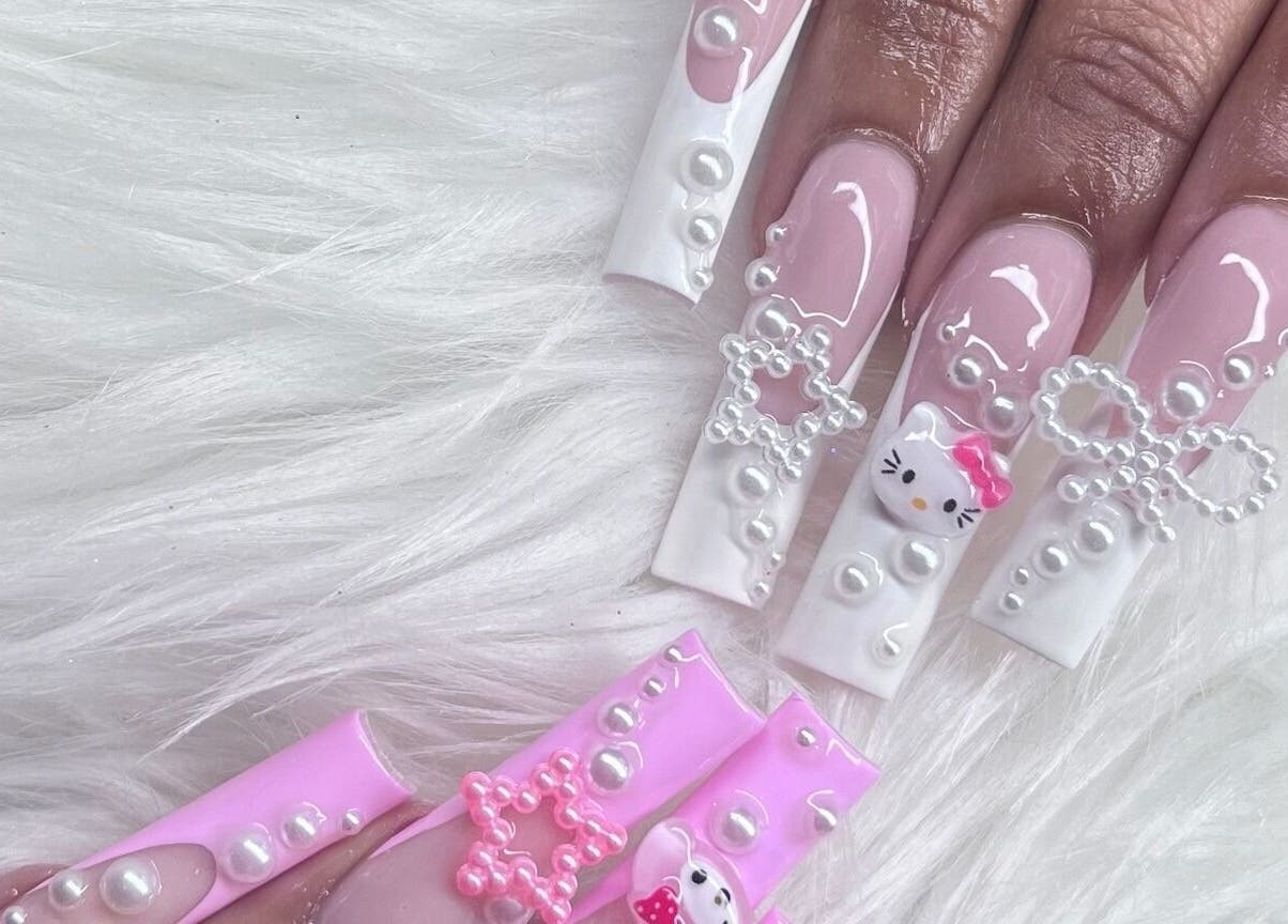 Elegant pink and pearl embellished nails at Angel Nails & Head Spa, Denton, Texas, US.
