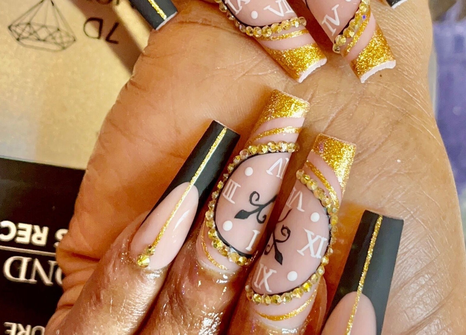 Intricate gold and black nail art at Angel Nails & Head Spa, Denton, Texas, US enhancing beauty.