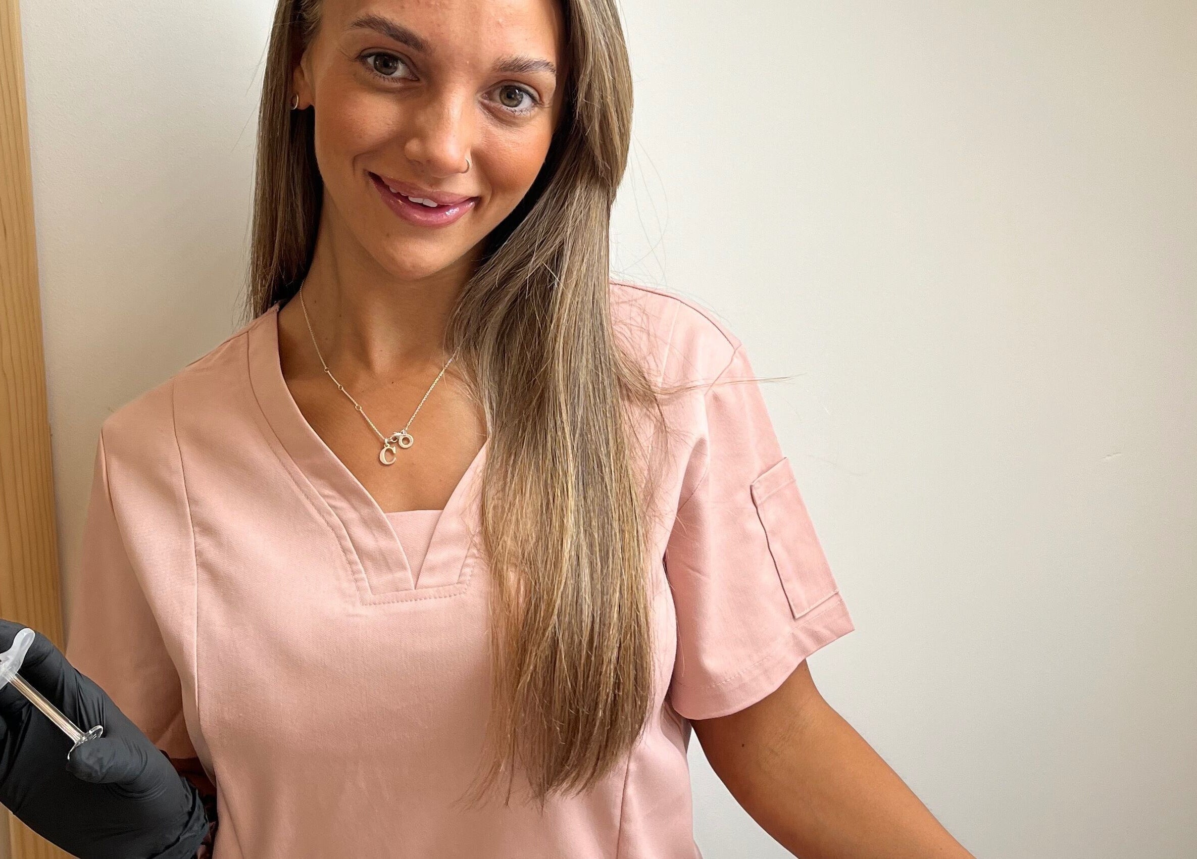 Aesthetician at Natural+ in Hapton, England, GB, holding a syringe, showcasing modern beauty treatments.