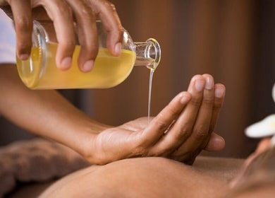 Massage oil pouring at Golden Feet Reflexology in Tempe, Arizona, US, enhancing relaxation and wellness.