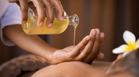 Massage oil pouring at Golden Feet Reflexology in Tempe, Arizona, US, enhancing relaxation and wellness.
