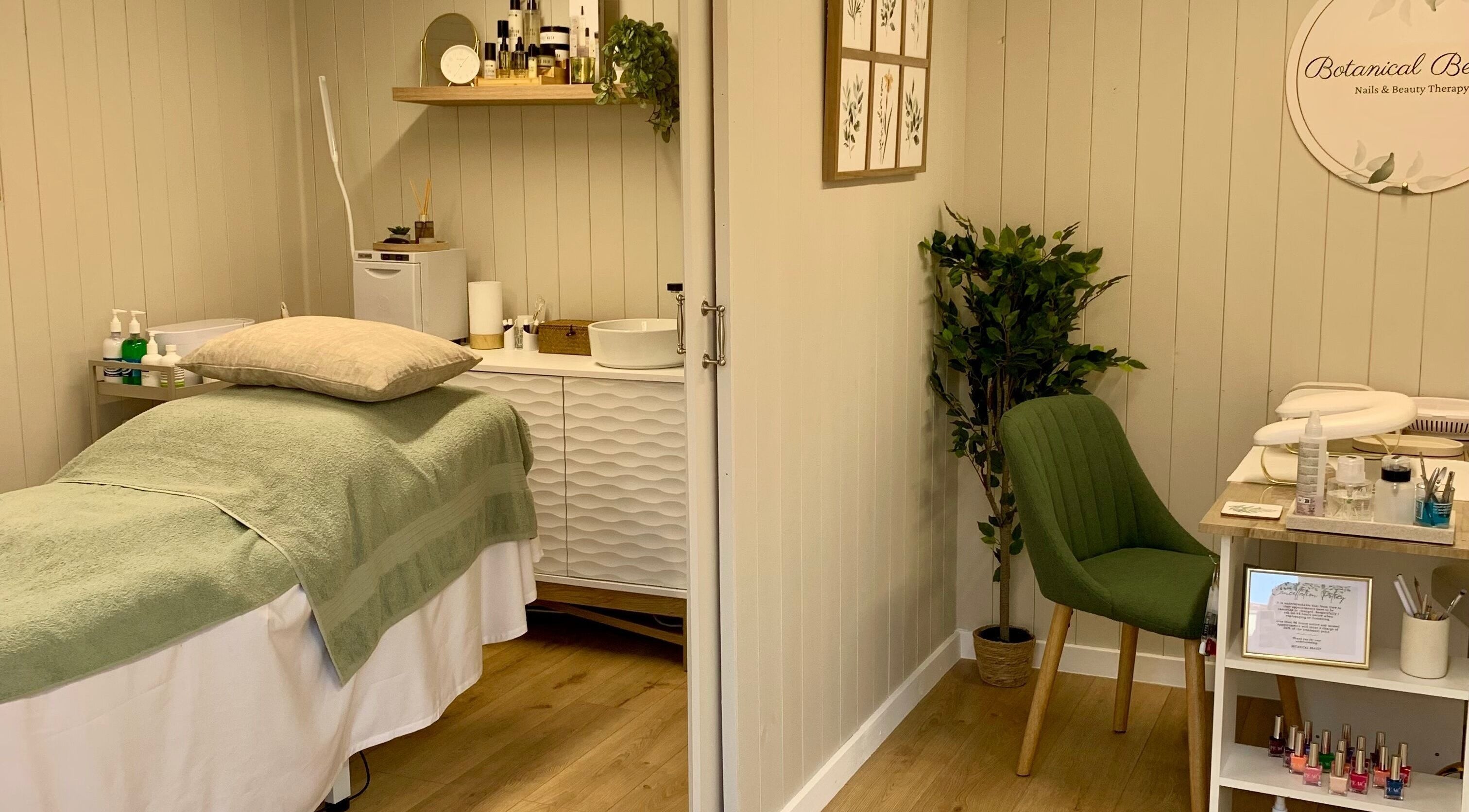 Relaxing treatment room at Botanical Beauty in Swadlincote, England, GB, with soothing decor and plush green chair.