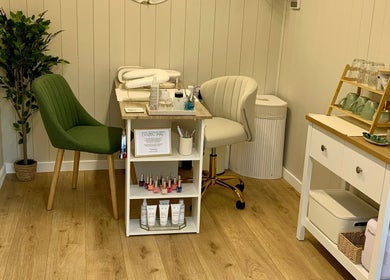 Cozy treatment corner at Botanical Beauty, Swadlincote, England, GB. Featuring green chair and beauty essentials.