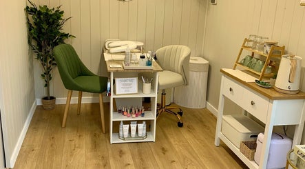Cozy treatment corner at Botanical Beauty, Swadlincote, England, GB. Featuring green chair and beauty essentials.